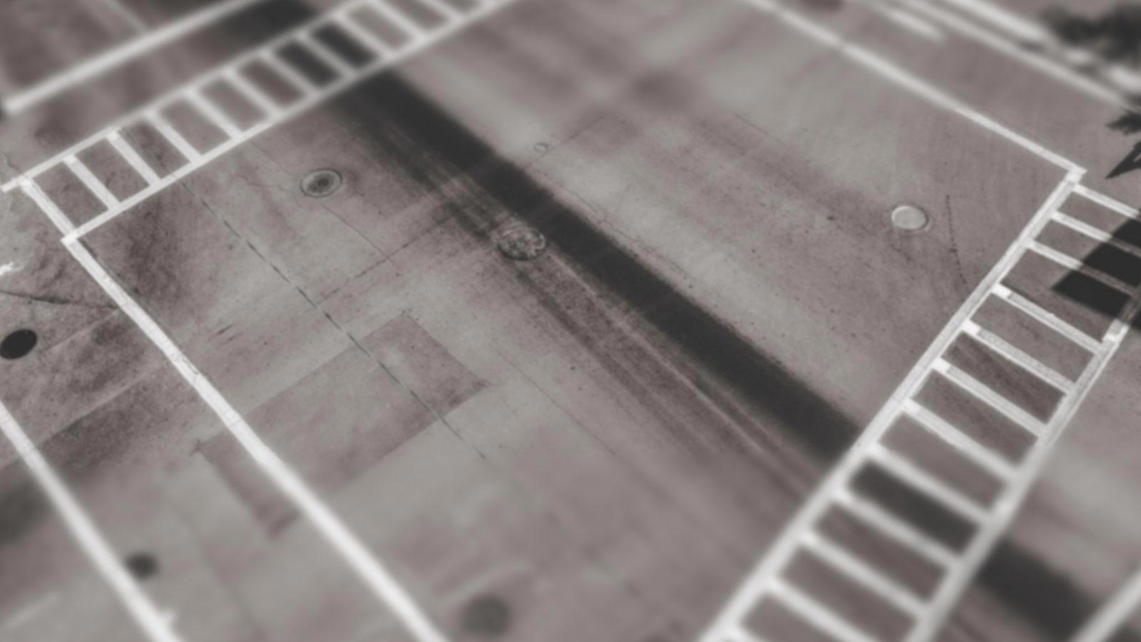 Black-and-white aerial view of four crosswalks forming a square at a street intersection, symbolizing clear boundaries and structured paths. Black-and-white aerial view of four crosswalks forming a square at a street intersection, symbolizing clear boundaries and structured paths.